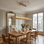 Sora Linear Chandelier hanging over a modern minimalist kitchen island.